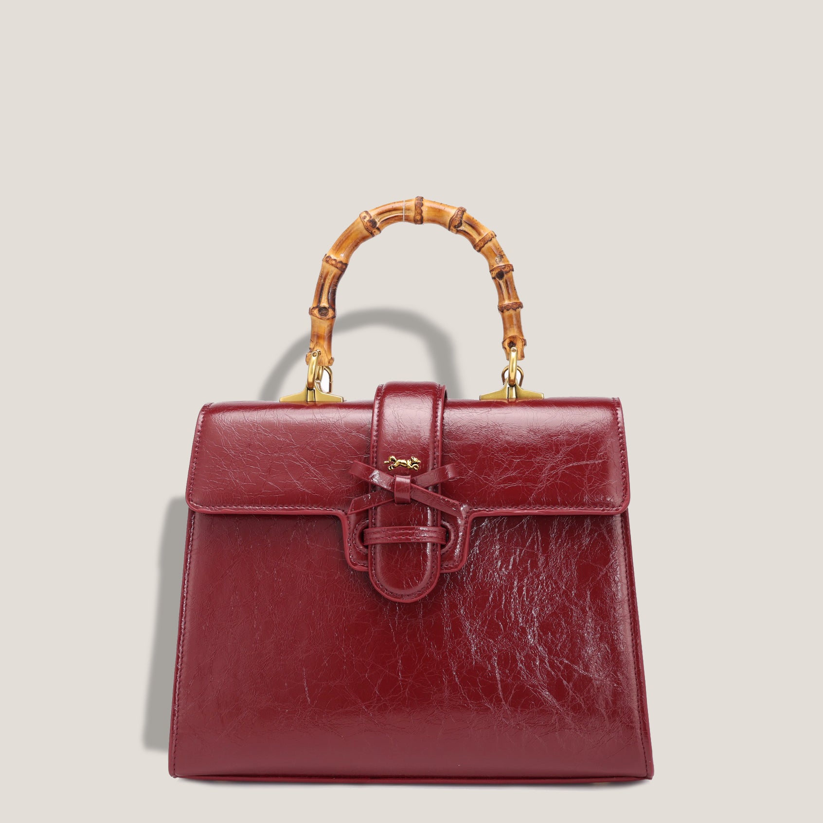 THE CARLTON BOW BAG PETITE - BURGUNDY "Crushed Patent"